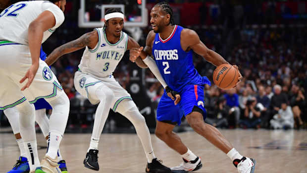 Los Angeles Clippers forward Kawhi Leonard moves the ball against Minnesota Timberwolves forward Jaden McDaniels during the second half at Crypto.com Arena in Los Angeles on Feb. 12, 2024.